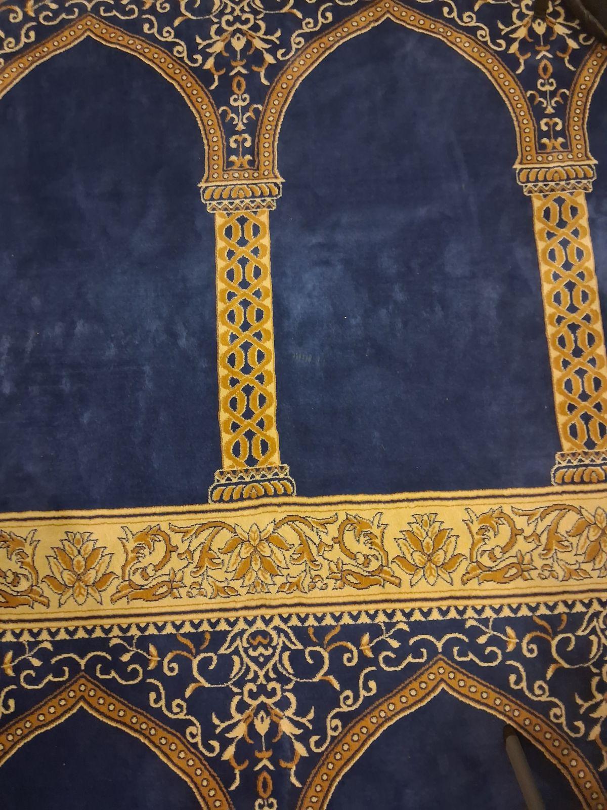Masjid Al-Ihsan carpet — deep blue and gold geometric pattern